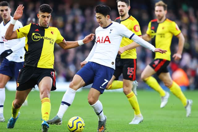 Heung-min Son of Tottenham Hotspur tackles with Adam Masina (Photo by Richard Heathcote/Getty Images)