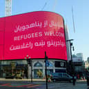 The London Mayor’s Welcome Message to the Afghan Refugees is displayed at Piccadilly Circus is also displayed in Dari and Pashto. Credit: Joe Maher/Getty Images
