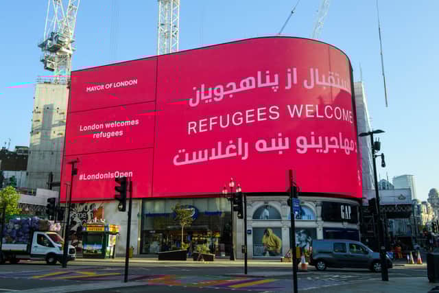 The London Mayor’s Welcome Message to the Afghan Refugees is displayed at Piccadilly Circus is also displayed in Dari and Pashto. Credit: Joe Maher/Getty Images
