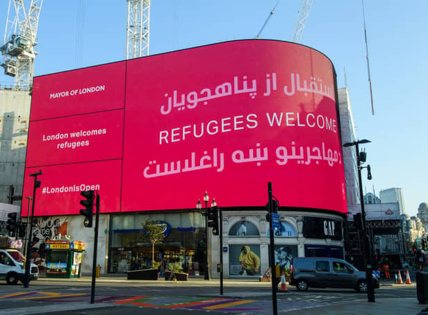 <p>The London Mayor’s Welcome Message to the Afghan Refugees is displayed at Piccadilly Circus is also displayed in Dari and Pashto. Credit: Joe Maher/Getty Images</p>