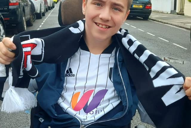 Fulham fan Rhys on his way to Craven Cottage. Credit: Kelly Porter