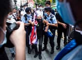 Activist Alexandra Wong (C), also known as Grandma Wong, is taken away by police while protesting on the 24th anniversary of Hong Kong's handover from Britain, in Hong Kong on July 1, 2021. (Photo by ISAAC LAWRENCE / AFP) (Photo by ISAAC LAWRENCE/AFP via Getty Images)