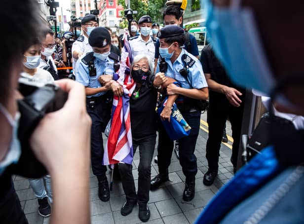 <p>Activist Alexandra Wong (C), also known as Grandma Wong, is taken away by police while protesting on the 24th anniversary of Hong Kong's handover from Britain, in Hong Kong on July 1, 2021. (Photo by ISAAC LAWRENCE / AFP) (Photo by ISAAC LAWRENCE/AFP via Getty Images)</p>