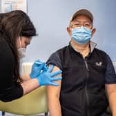Booster jabs are being rolled out to over-50s. Pictured, a man is given a Covid vaccine at a London vaccination centre.