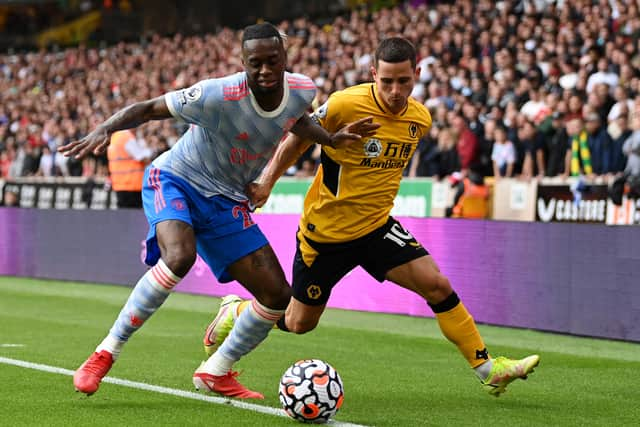 Aaron Wan-Bissaka of Manchester United battles for possession with Daniel Podence (Photo by Shaun Botterill/Getty Images)