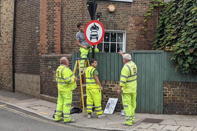 Workers installing signs for a new low-traffic neighbourhood. Credit: LDRS