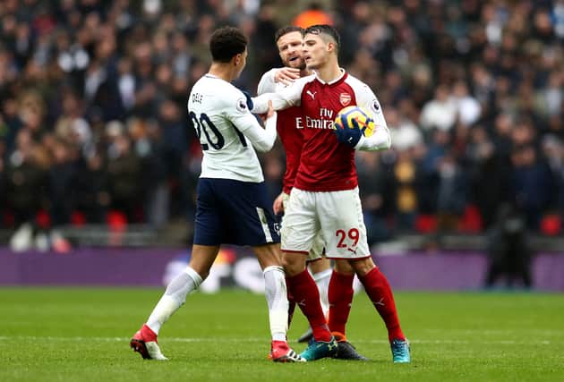 Dele Alli of Tottenham scraps with Granit Xhaka of Arsenal. The North London derby is this weekend. Credit:  Catherine Ivill/Getty Images
