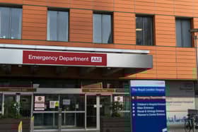 London / England - NHS Modern Royal London Hospital entrance to accident & emergency service & department. Direction signboard showing ways around the hospital. National Health Service