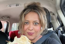 Lily Potkin eating her Nados in the queue for fuel in Kingsbury, northwest London. Credit: SWNS