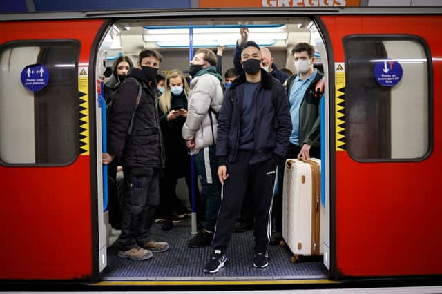Londoners on the Tube. (Photo by TOLGA AKMEN/AFP via Getty Images)