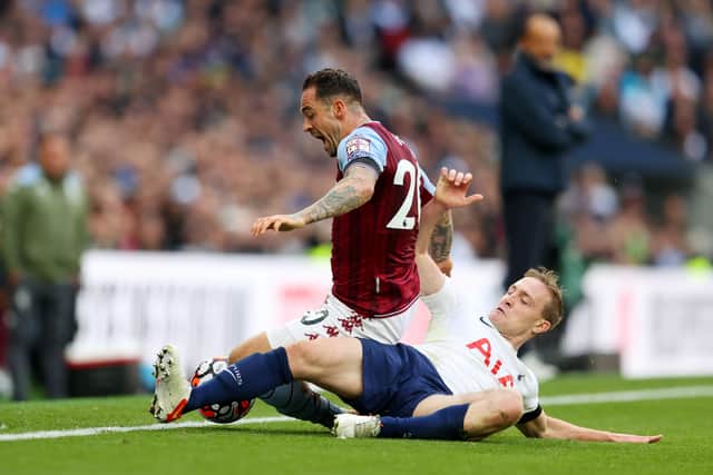 Oliver Skipp of Tottenham Hotspur tackles Danny Ings (Photo by Catherine Ivill/Getty Images)