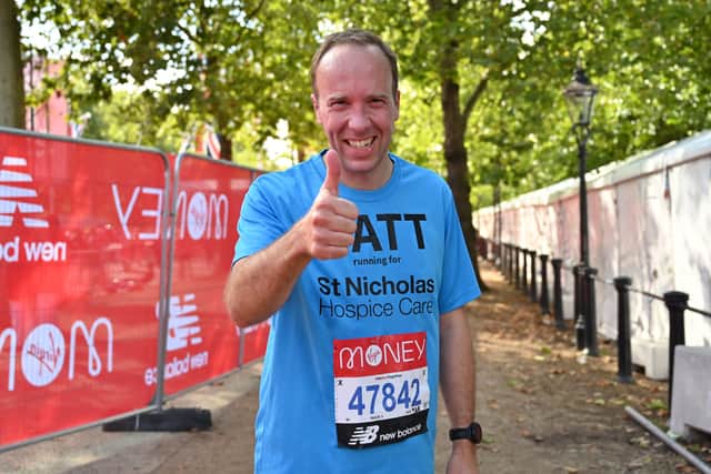 Conservative politician Matt Hancock gestures to the camera after completing the 2021 London Marathon in central London on October 3, 2021. (Photo by GLYN KIRK/AFP via Getty Images)