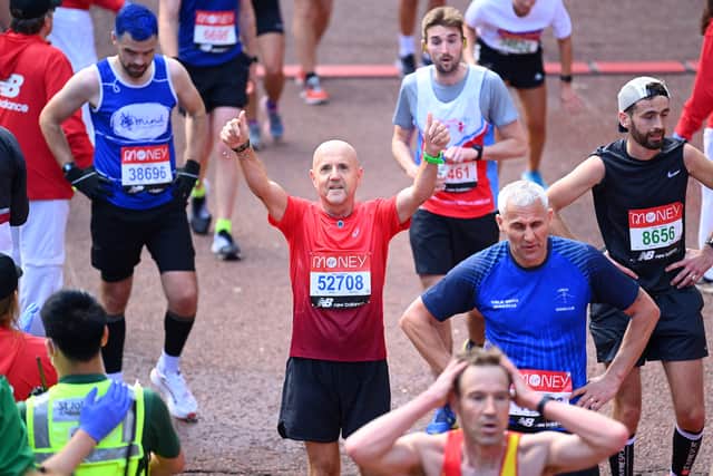 Members of the public finish during the 2021 Virgin Money London Marathon at Tower Bridge on October 03, 2021 in London, England. (Photo by Alex Davidson/Getty Images)