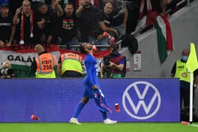 Hungary’s fans react throwing cups of beer at England’s forward Raheem Sterling as he celebrates scoring the opening goal in the World Cup qualifier last month. Credit: ATTILA KISBENEDEK/AFP via Getty Images