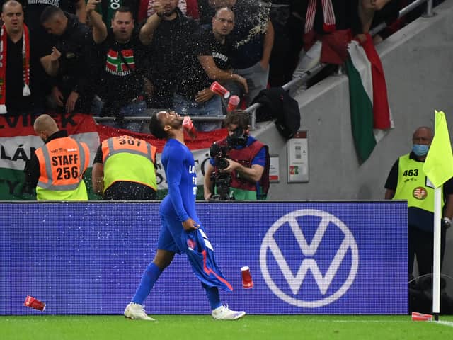 Hungary’s fans react throwing cups of beer at England’s forward Raheem Sterling as he celebrates scoring the opening goal in the World Cup qualifier last month. Credit: ATTILA KISBENEDEK/AFP via Getty Images