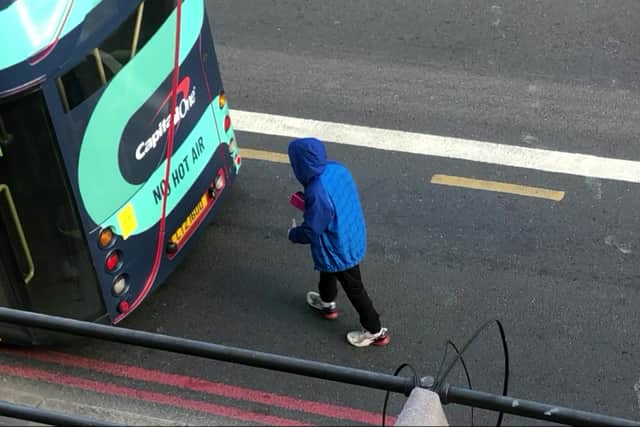 The moment a man kicks the bus before hurling racist abuse at the driver. Credit: SWNS