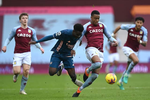 Bukayo Saka of Arsenal and Ezri Konsa of Aston Villa battle for possession during the Premier League  (Photo by Shaun Botterill/Getty Images)