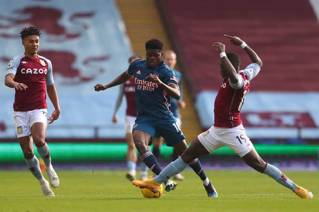 Thomas Partey of Arsenal is tackled by Marvelous Nakamba of Aston Villa during the Premier League match (Photo by Catherine Ivill/Getty Images)