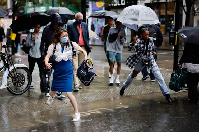 Commuters deal with horrendous rain in London. 