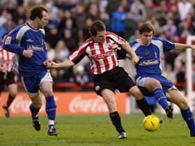 Jay Tabb of Brentford holds off Steve Jenkins (L) and Grant Smith of Swindon Town during the Coca-Cola First Division match (Photo by Ker Robertson/Getty Images)