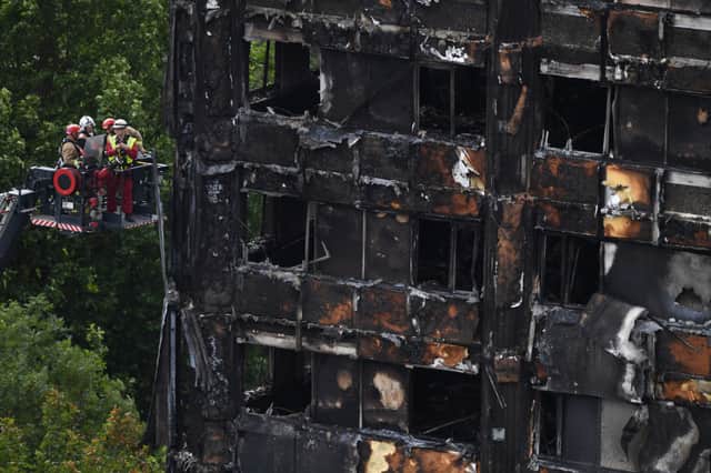 Emergency workers inspect the remains of Grenfell Tower. Credit: CHRIS J RATCLIFFE/AFP via Getty Images