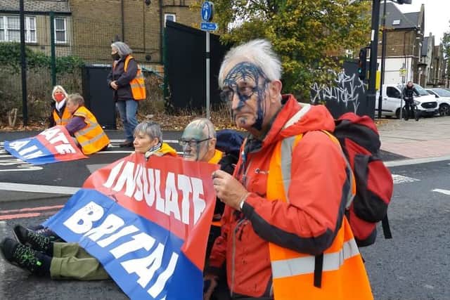 Insulate Britain protesters have ink thrown over them, as they block A40 in North Acton. Credit: Insulate Britain