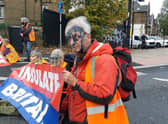 Insulate Britain protesters have ink thrown over them, as they block A40 in North Acton. Credit: Insulate Britain