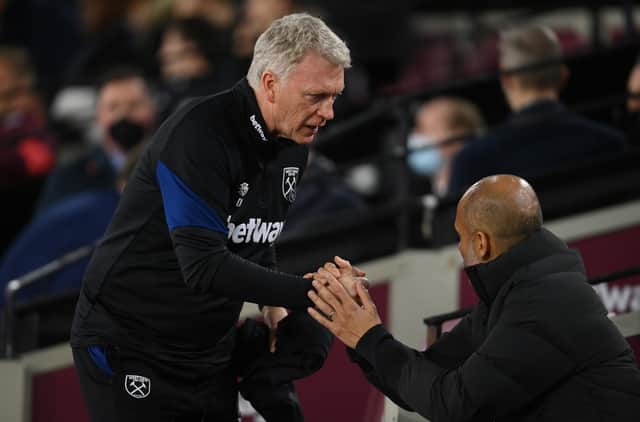 David Moyes, manager of West Ham United, with Pep Guardiola Credit: Getty