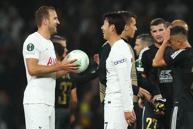 Harry Kane of Tottenham Hotspur is presented with the match ball by teammate Heung-Min Son (Photo by Clive Rose/Getty Images)