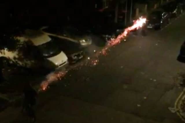 A boy on a bike shoots a firework past the Just Eat driver in Hackney. Credit: SWNS