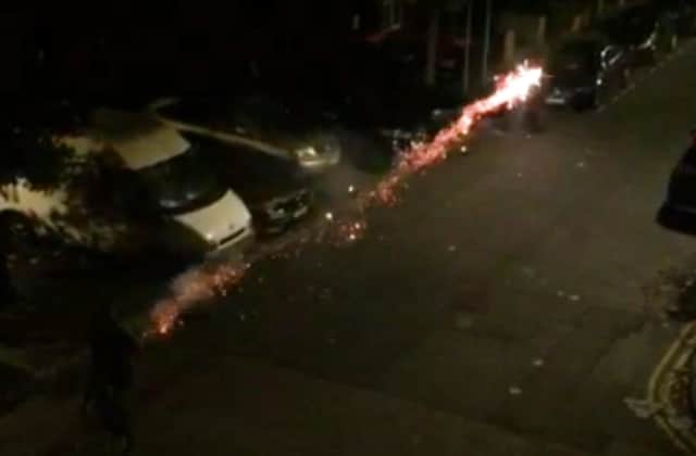A boy on a bike shoots a firework past the Just Eat driver in Hackney. Credit: SWNS