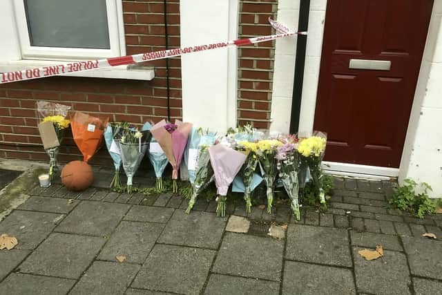Police and floral tributes at the scene in Brentford, west London, where Ali Abucar Ali was killed. Credit: Gwyn Wright / SWNS