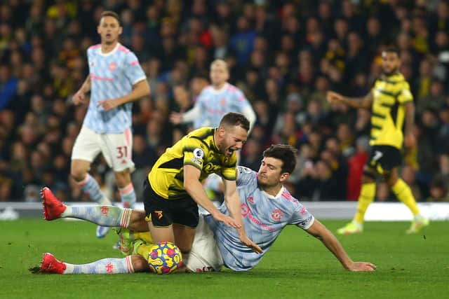 Tom Cleverley of Watford FC is fouled by Harry Maguire of Manchester United (Photo by Charlie Crowhurst/Getty Images)