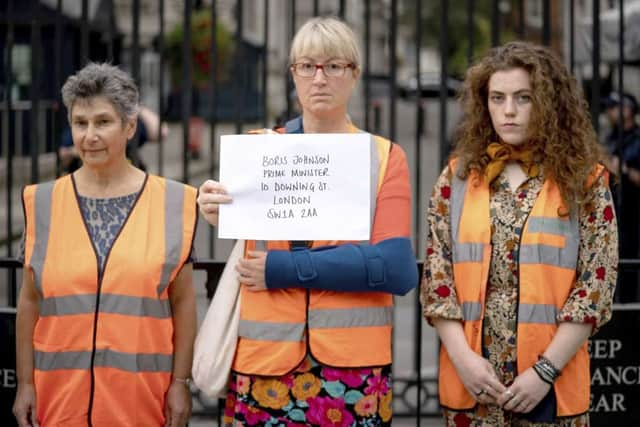 Emma Smart delivering a letter to 10 Downing Street. Credit: Insulate Britain