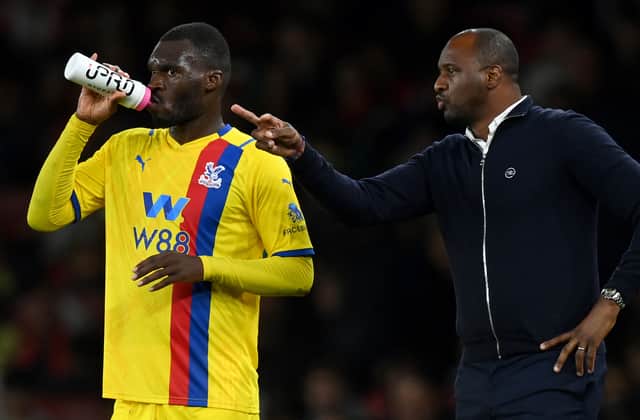 Crystal Palace’s French manager Patrick Vieira (R) gestures as Crystal Palace’s Zaire-born Belgian striker Christian Benteke takes a drink  (Photo by GLYN KIRK/AFP via Getty Images)