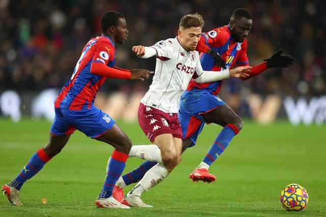 Matty Cash of Aston Villa battles for possession with Tyrick Mitchell and Cheikhou Kouyate (Photo by Clive Rose/Getty Images)