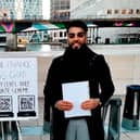 Haider Malik, 24, set up a pop-up stand with QR codes to his CV and LinkedIn page outside Canary Wharf in London. Photo: Haider Malik/SWNS