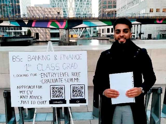 Haider Malik, 24, set up a pop-up stand with QR codes to his CV and LinkedIn page outside Canary Wharf in London. Photo: Haider Malik/SWNS