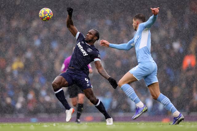 Michail Antonio of West Ham United battles for possession with Ruben Dias of Manchester (Photo by Naomi Baker/Getty Images)
