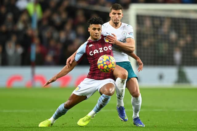 Ollie Watkins of Aston Villa holds off Ruben Dias of Manchester City during the Premier League match between Aston Villa and Manchester City at Villa Park