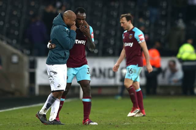 Andre Ayew of Swansea City speaks with Michail Antonio of West Ham United  (Photo by Jan Kruger/Getty Images)