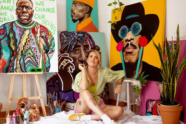 Charlotte Archer with her portraits.
