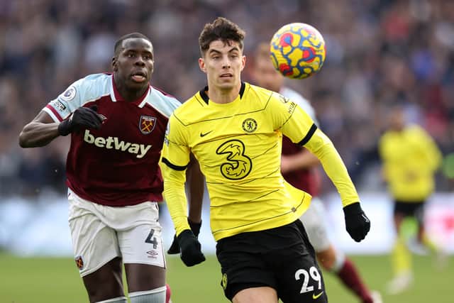 Kai Havertz of Chelsea runs with the ball from Kurt Zouma of West Ham United (Photo by Alex Pantling/Getty Images)
