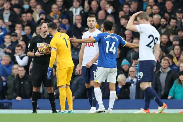 Match Referee, Chris Kavanagh interacts with Hugo Lloris of Tottenham Hotspur (Photo by Clive Brunskill/Getty Images)