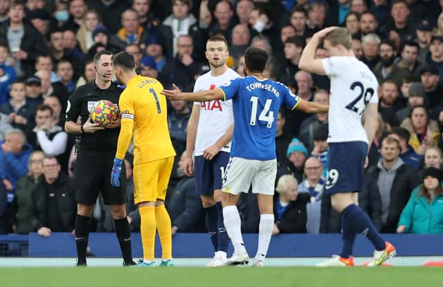 Match Referee, Chris Kavanagh interacts with Hugo Lloris of Tottenham Hotspur (Photo by Clive Brunskill/Getty Images)
