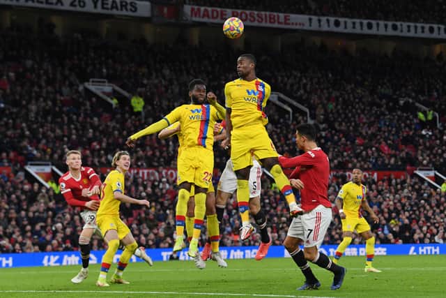 Crystal Palace’s French striker Odsonne Edouard and Crystal Palace’s English defender Marc Guehi jump (Photo by PAUL ELLIS/AFP via Getty Images)