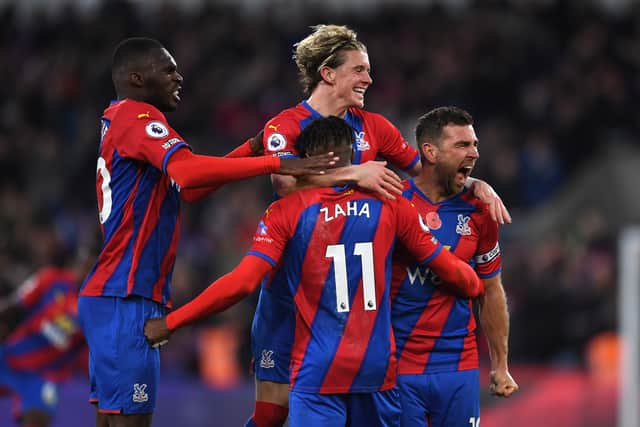 Conor Gallagher celebrates with teammates Christian Benteke and Wilfried Zaha (Photo by Tom Dulat/Getty Images)