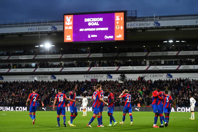 Crystal Palace players celebrate after a VAR decision gives them a goal during the Premier League (Photo by Tom Dulat/Getty Images)
