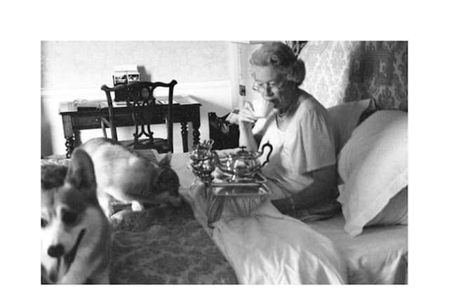 A faux picture of the Queen having breakfast with her corgis. Credit: Alison Jackson