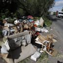 Fly-tipped rubbish and waste is seen beside a road in Colnbrook, near Heathrow (image: AFP via Getty Images)